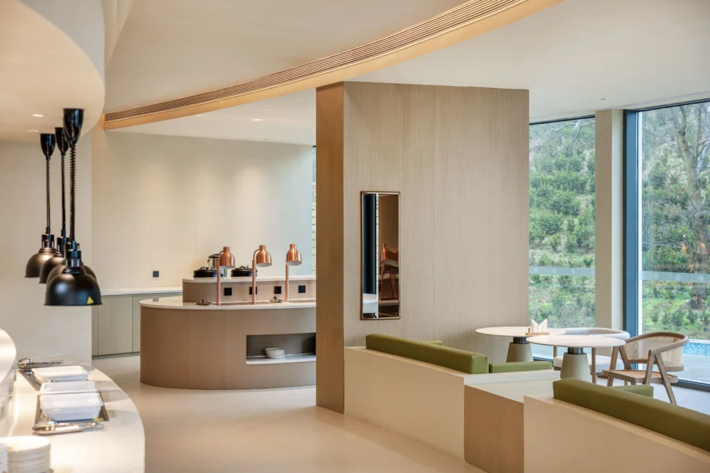 modern hotel buffet with curved counters copper heat lamps nature view