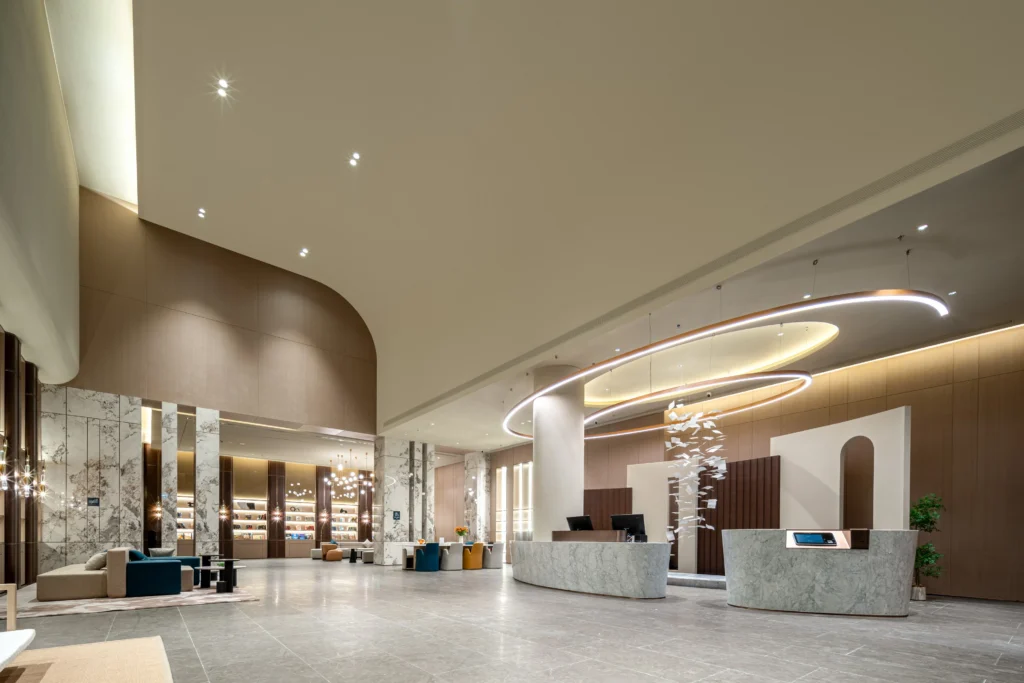 Grand lobby statement decorative hotel wall cladding with marble columns wood panels reception desk seating lighting