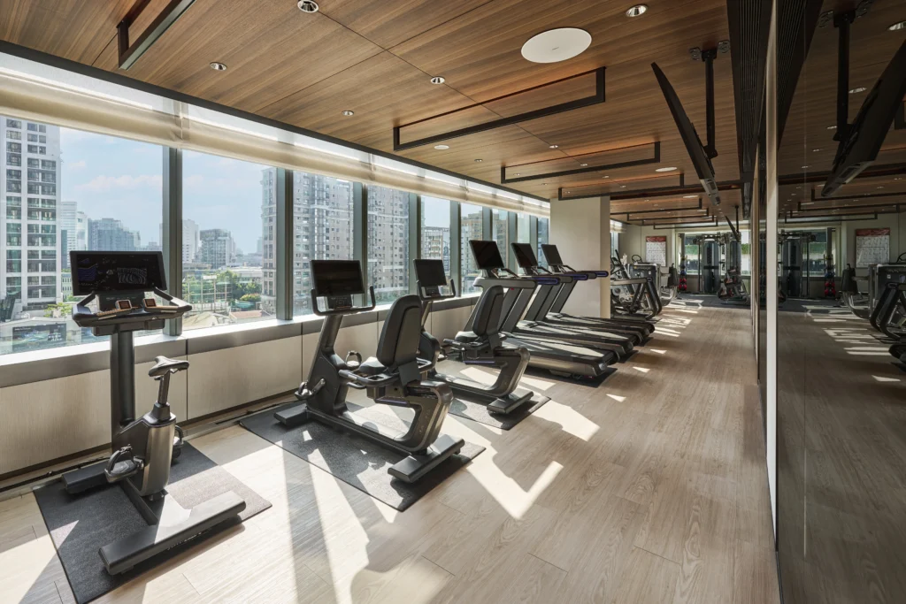 Custom hotel wellness and recreation fit-out with wall panels, storage cabinets and floor-to-ceiling glazing